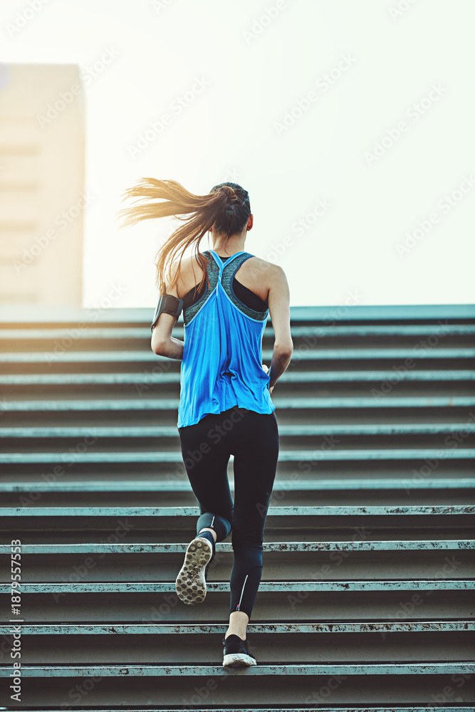 Naklejka premium Back, running and woman on stairs for fitness, training and exercise for wellness. Outdoor, female person and runner for workout, muscle development and endurance with health challenge in New York