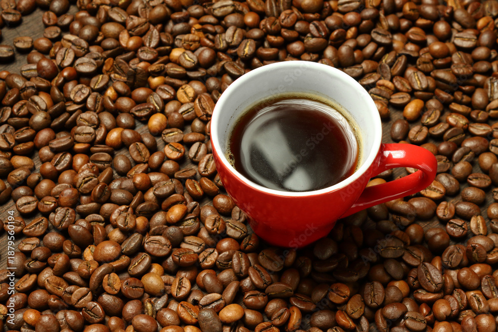 Fototapeta premium Red Mug of Black Coffee on Roasted Beans Bed
