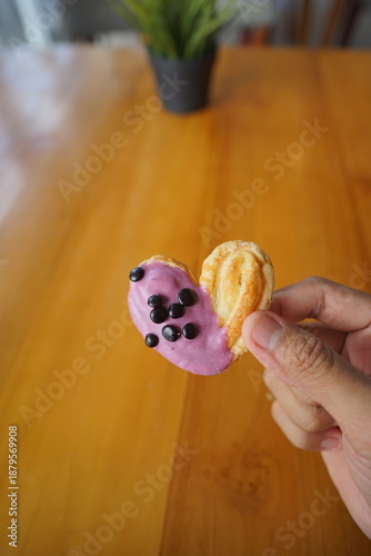 a cupcake on a white plate on a wooden table, breakfast menu in the morning, with natural lighting in the morning
