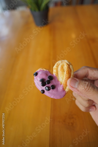 a cupcake on a white plate on a wooden table, breakfast menu in the morning, with natural lighting in the morning