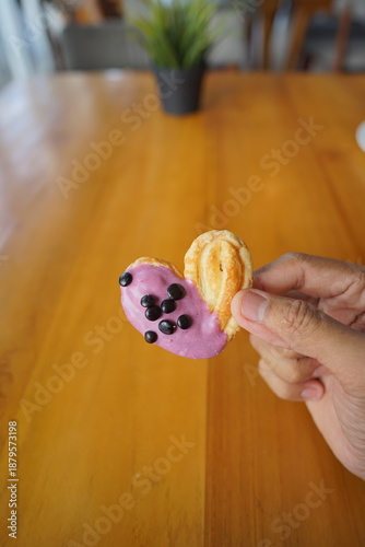 a cupcake on a white plate on a wooden table, breakfast menu in the morning, with natural lighting in the morning