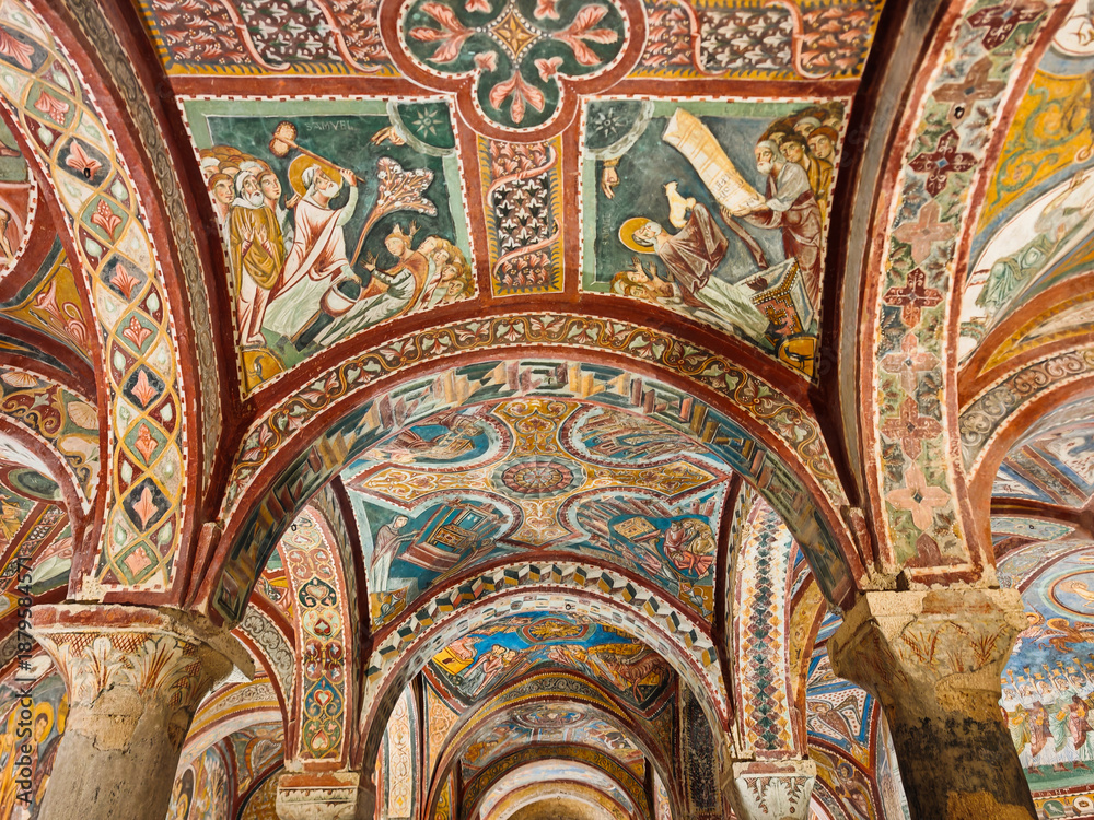 Naklejka premium Detailed view of the intricately frescoed vaulted ceiling and arches within the historic medieval Crypt of San Magno, Anagni Cathedral, Lazio, Italy