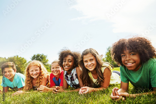 Fotografía Portrait, friends and children on lawn with smile, bonding and diversity together on vacation