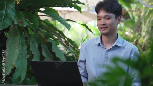 Remote professional attending an online conference call from a peaceful outdoor tropical workspace