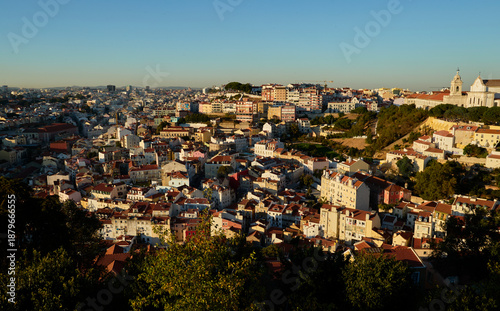 High angle view of Lisbon cityscape with red roofs and Monastery of Sao Vicente de Fora at sunset, Portugal