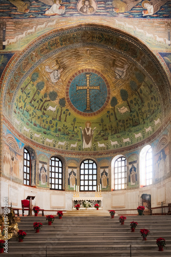 Ornate Byzantine apse mosaic in the Basilica of Sant'Apollinare in Classe in Ravenna, Italy, with religious symbolism.