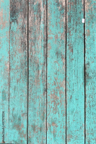 Weathered turquoise wooden planks with peeling paint and rough grain texture. Rustic distressed wood background ideal for vintage design, coastal themes, shabby chic decor, or abstract backdrops.