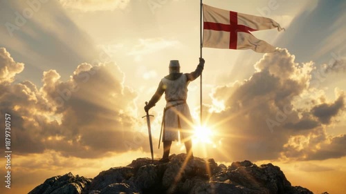Silhouette of a medieval knight in armor standing on a rocky peak with a sword and St. George's flag. Heroic warrior against a dramatic sunset sky with sun rays. Victory and conquest concept