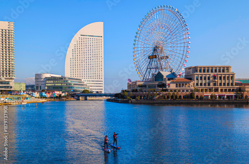 Obraz na plátně Yokohama Bay skyline with modern architecture and highrising buildings along the boardwalk in Kanagawa, Japan, a calm and beautiful waterfront cityscape at the edge of the bay