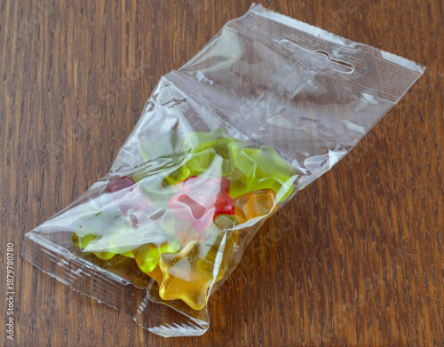 Unbranded clear plastic bag with gelly bon stars on wooden top