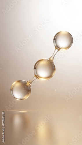 A close-up of three transparent spheres representing collagen peptide molecules, showcasing liquid bonds with a golden glow against a blurred background.