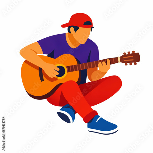 Young man playing acoustic guitar sitting cross-legged