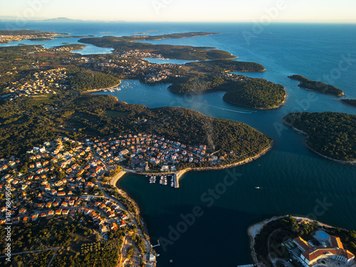 Quadro su tela Pula Croatia aerial drone view of island coastline Adriatic sea bay and moored boats