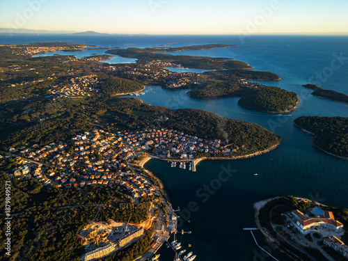 Foto Pula Croatia aerial drone view of island coastline Adriatic sea bay and moored boats