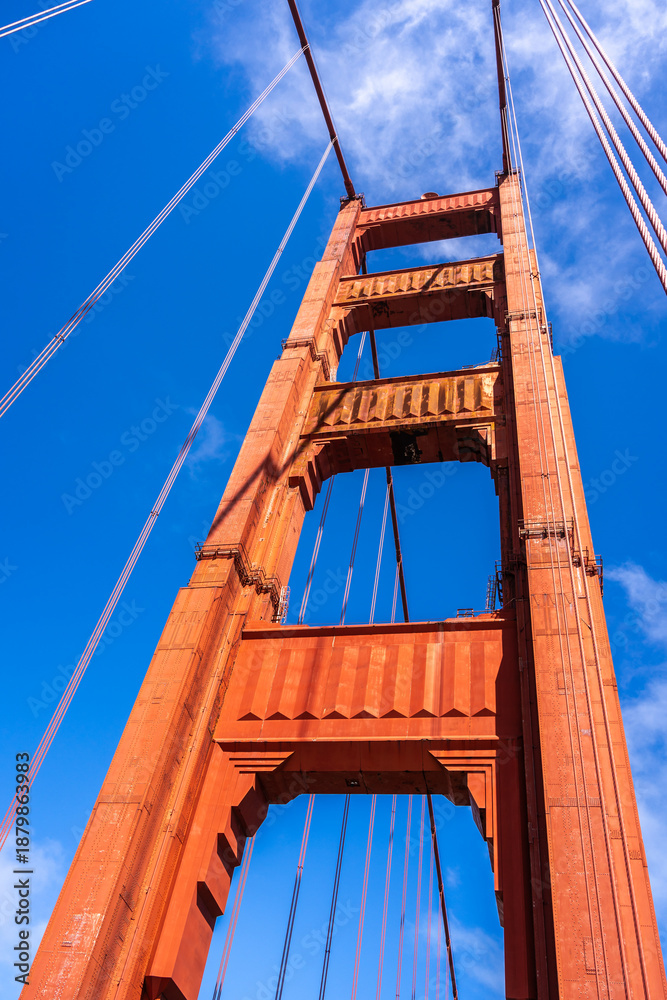 Fototapeta premium Golden Gate Bridge pedestrian walkway with red cables and blue sky
