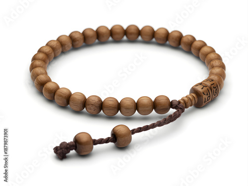A wooden beaded bracelet with a brown cord and a decorative clasp on a white background