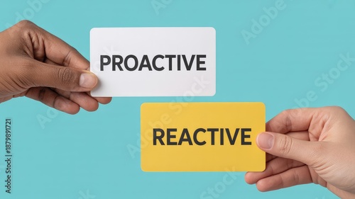 Hands holding proactive and reactive cards for business strategy