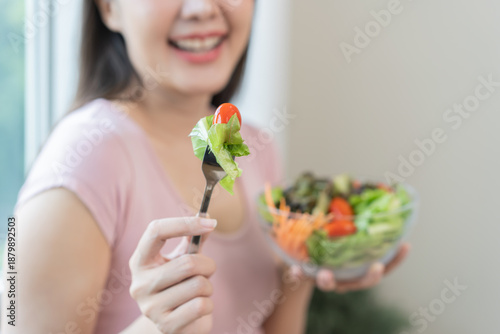 Φωτογραφία Diet concept, happy smile asian young woman use fork to prick tomato, fresh vegetable or green salad, eat nutrition food isolated on background, low fat to good body, getting weight loss for healthy