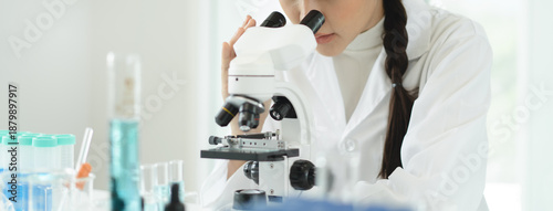 Canvastavla researcher using microscope analyse cell in medical lab.
