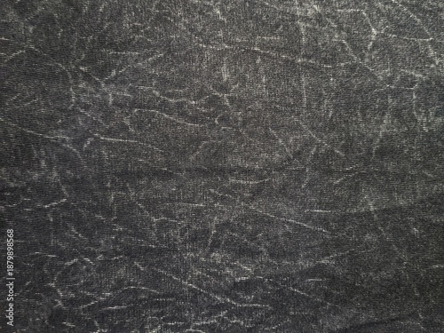 Black acid wash denim texture background with white distressed streaks
