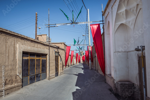 фотографія Red flags on the narrow street of Old Town of Kashan, Iran