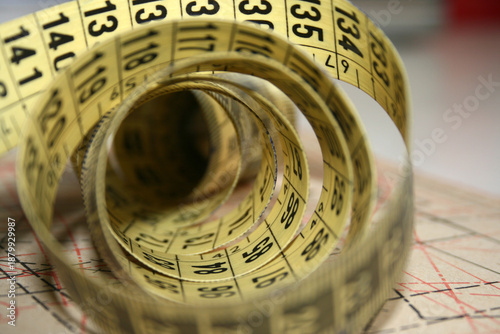 Yellow tailor's measuring tape in centimetres at working desk
