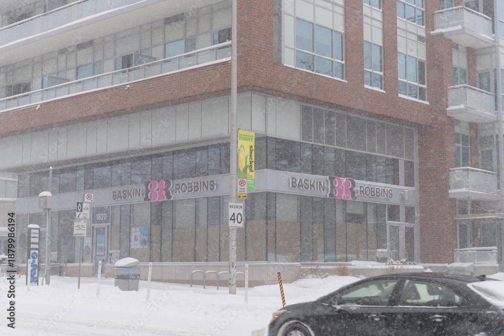 Fototapeta premium future location of a Baskin‑Robbins at 1820 Bloor St W during a snow storm on 2026-01-15 in Toronto