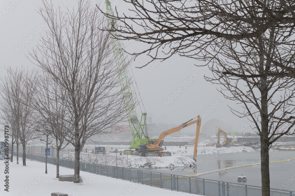 Fototapeta premium heavy equipment at Ontario Place redevelopment during a snow storm on 2026-01-15 in Toronto