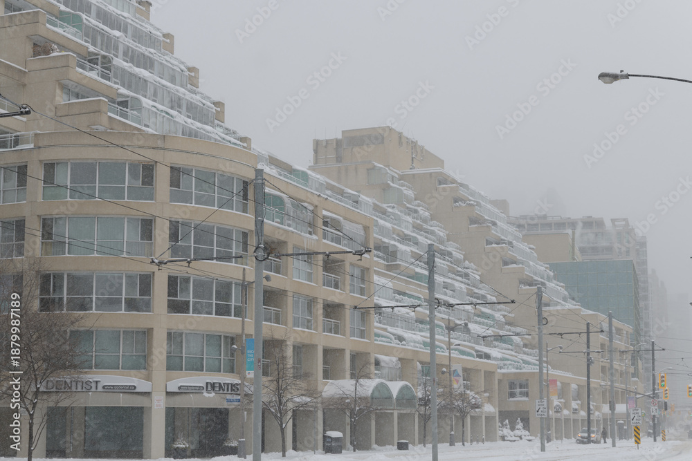 Obraz premium wide view of Kings Landing designed by Arthur Erickson located at 480 Queens Quay W during a snow storm on 2026-01-15 in Toronto