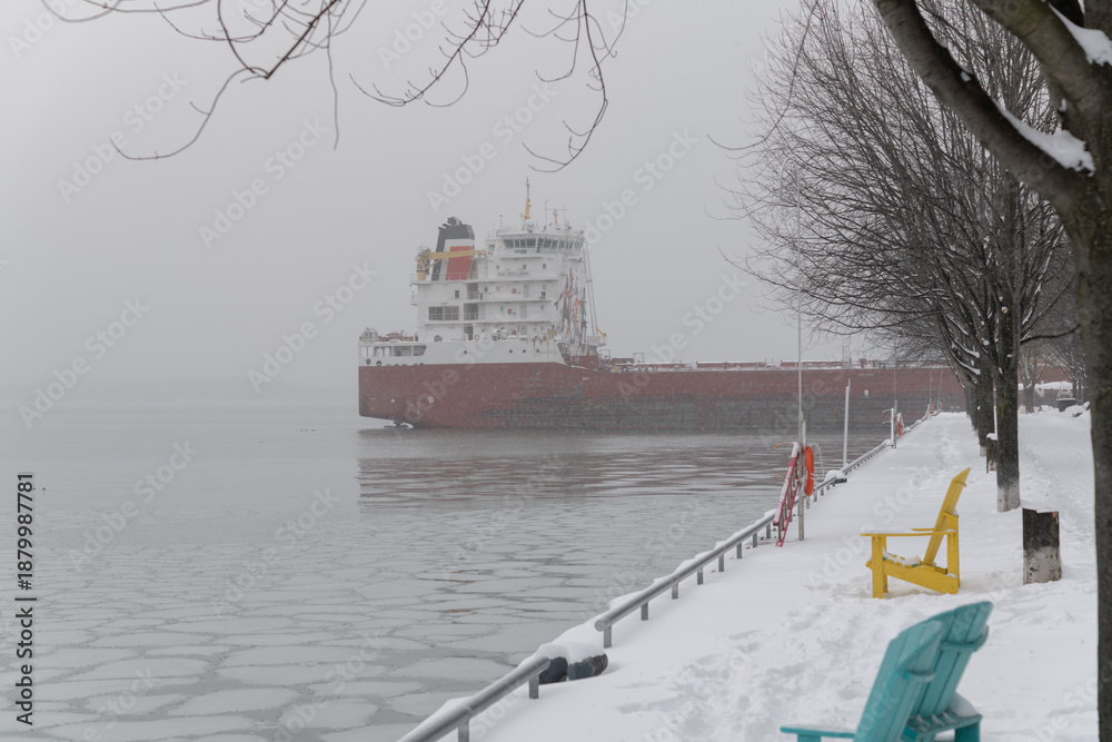 Fototapeta premium CSL Welland (self-unloading bulk carrier) with sugar cargo docked at Redpath Sugar Refinery located at, 95 Queens Quay E, during a snow storm on 2026-01-15 in Toronto