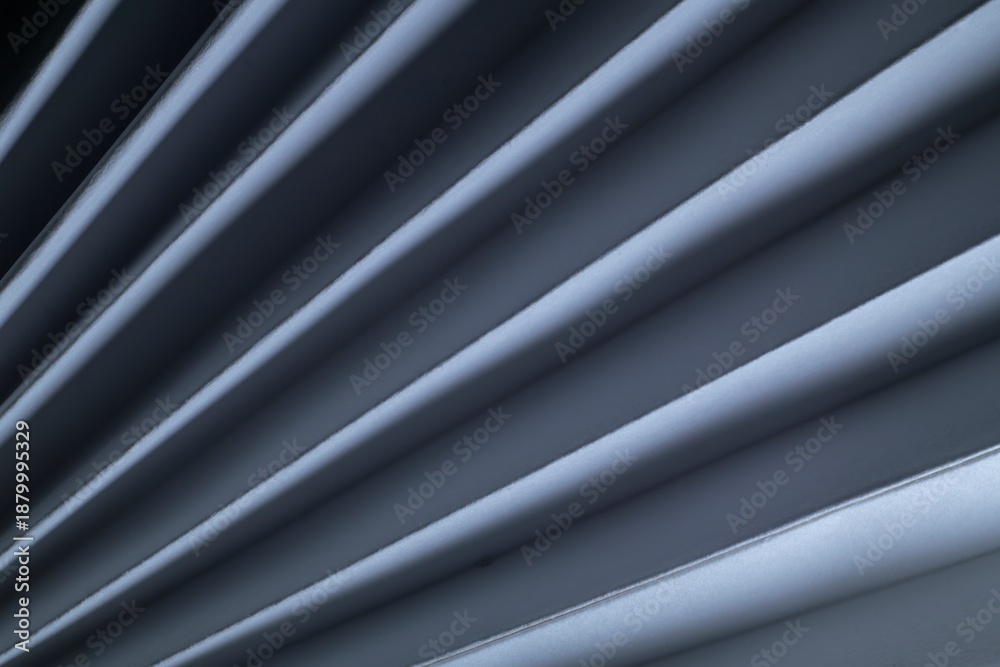 Fototapeta premium Geometric composition of a paper fan in soft lighting.