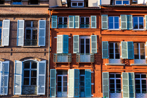 Brick façades facing Place Saint-Etienne illuminated by winter sunlight in central Toulouse