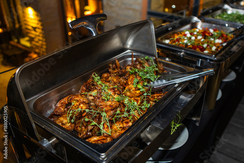 Foto Grilled chicken with basting in a silver tray