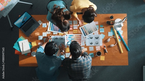 Top view of business team write graphic logo on meeting table with colorful sticky notes and design while explain idea. Project manager sharing idea and explain concept art to smart team. Symposium.