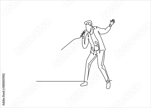 A male pop singer holding a microphone and singing.
