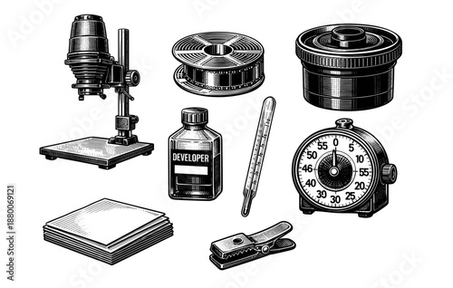 Vintage darkroom equipment including enlarger, thermometer, and timer