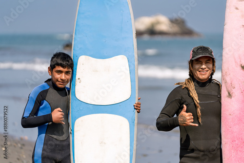 Surf instructor and young student ready for surfing lesson