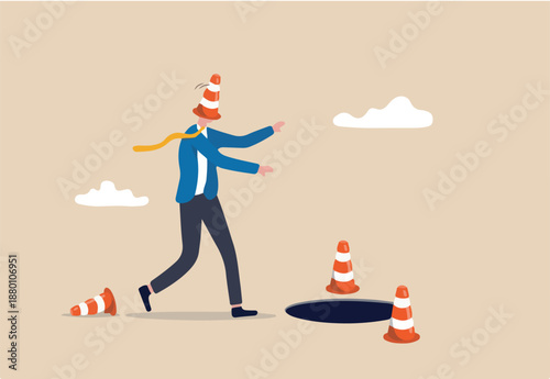 Blind and frustrated business direction, mistake or failure, trap or crisis ahead, risk and uncertainty concept, blindfold businessman cover with pylon walking to fall into the hole or business trap.