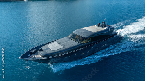 Photos Luxurious Yacht on the water: An eye-level shot captures a sleek, modern yacht gliding swiftly through tranquil waters, creating a striking visual impression
