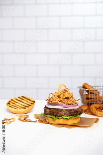 Burger with fried onions and onion rings