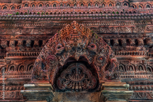 Fragment of the Mahabuddha temple facade with numerous Buddha statues. Patan (Lalitpur), Kathmandu, Nepal.