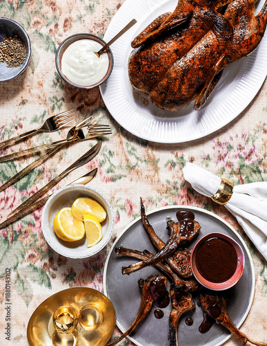 Roast Duck and Lamb Chops with Sauce on Elegant Floral Table Setting