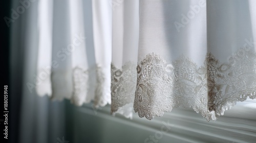 Close-up of a white curtain hanging on a window. the curtain is made of sheer fabric and has a delicate lace trim along the edges.