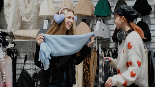 Obraz na plátně Two teenage friends are shopping for warm winter clothes.