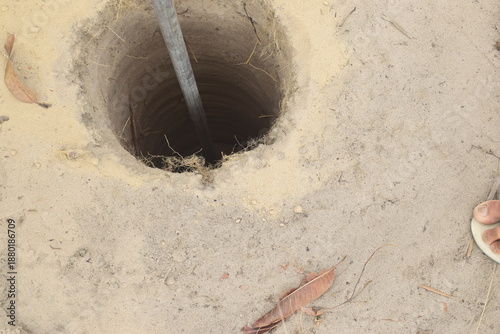 Konstfotografi Buraco profundo redondo com cano de ferro descendo para o fundo, escavação de po