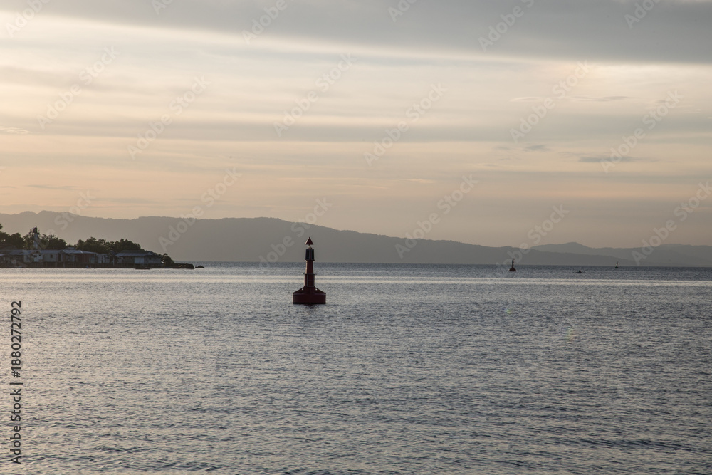 Fototapeta premium Marine Navigation Buoy in a bay in calm sea at sunset