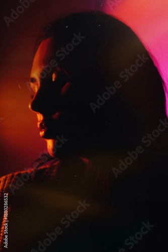 Dreamy moody cinematic portrait of a brunette woman with blue-pink aqua glow and long exposure