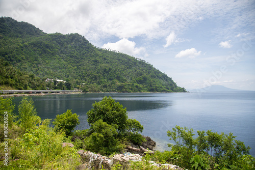 wide concrete road along the tropical coastline 