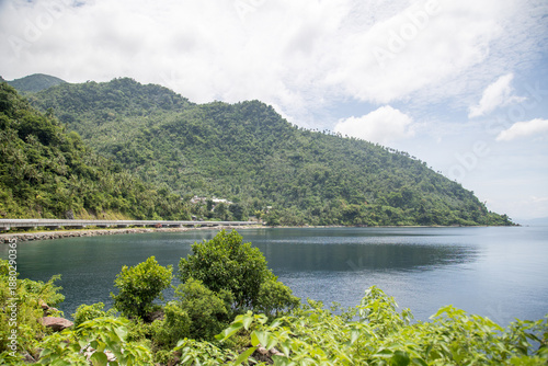 wide concrete road along the tropical coastline 
