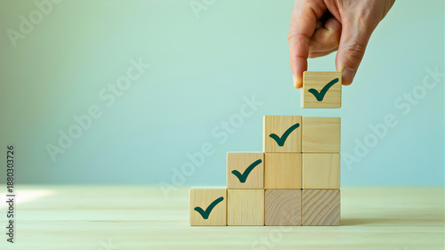 Successful Business Progress and Goal Achievement Hand Placing Final Checkmark Block on a Rising Wooden Staircase, Symbolizing Step-by-Step Task Completion and Milestones